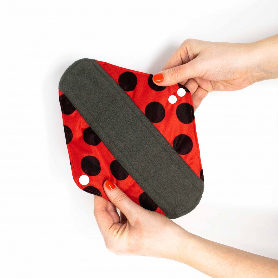 Hey Girls - hands holding unfolded Reusable Pad