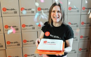 smiling Hannah with a celebratory cake 'hey 30 million'