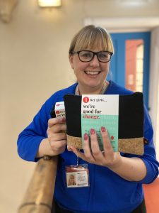 Canongate Youth Clare Jamieson Manager holding a hey girls products