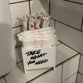 hey girls products with a sign saying 'take what you need'